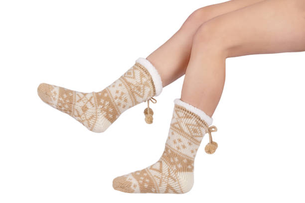 istock Women's brown sherpa winter socks with legs on white background 1224215339
