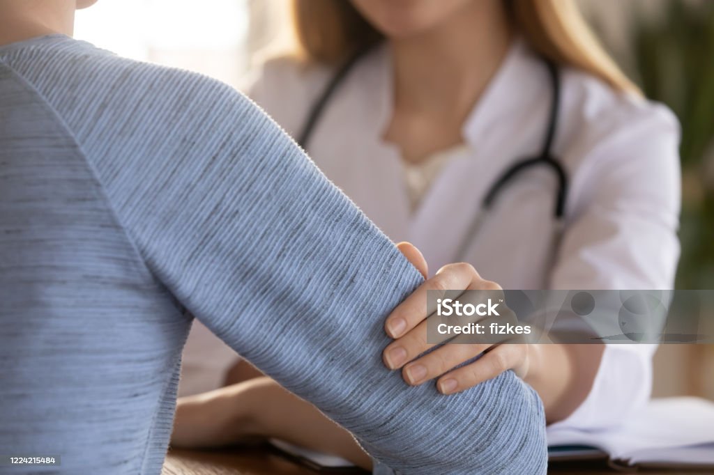 Female doctor support comfort patient at consultation Close up of woman doctor touch patient show care and empathy telling bad results news, supportive female GP or physician cheer comfort upset clients at consultation in hospital, healthcare concept Miscarriage Stock Photo