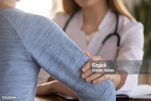 Female Doctor Support Comfort Patient At Consultation Stock Photo - Download Image Now