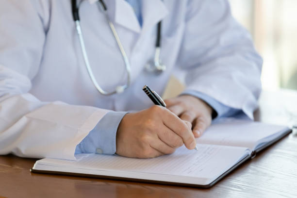 istock Close up of male make notes in medical journal 1224215539
