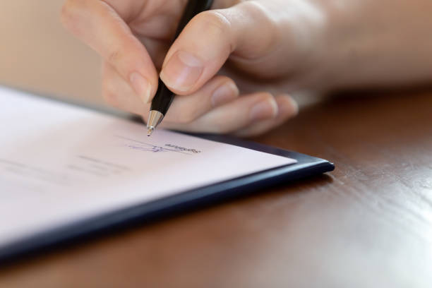 istock Close up of female patient sign document 1224215555