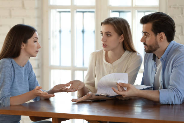 istock Angry couple argue with Real Estate Agent about contract rules 1224215574