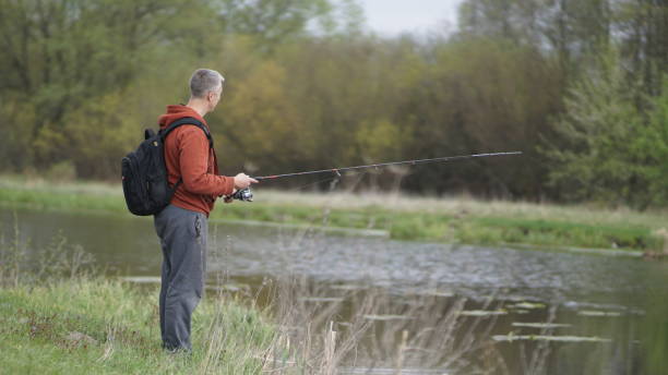 istock fishing man in a beautiful place in the meadow, spring 1224219233