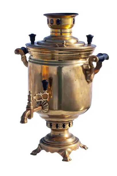 Copper samovar Isolated on a white background. A Russian kettle works on firewood. Reflections and reflections on a samovar. Russian hospitality. Vertical.