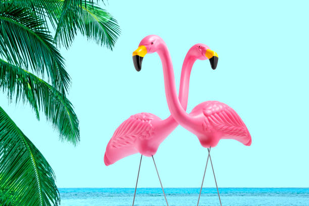 istock Two Decorative Pink Flamingos Framed By Palm Trees 1224222017