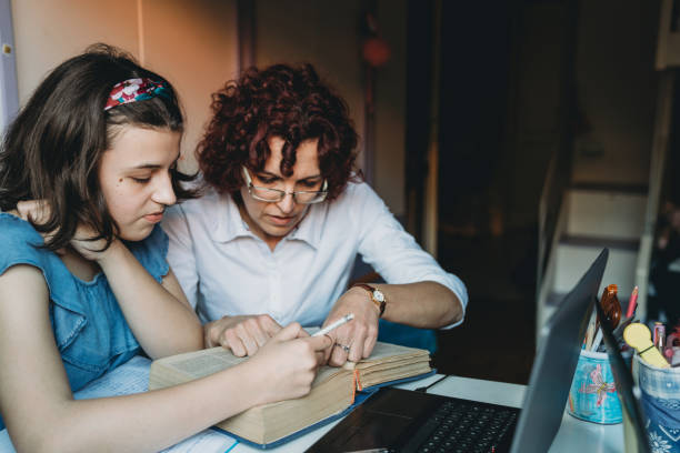istock Mother is helping her daughter with homework at home 1224222700