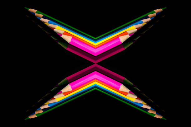 Rainbow bright colored  penciles on isolated black. Abstract education concept.