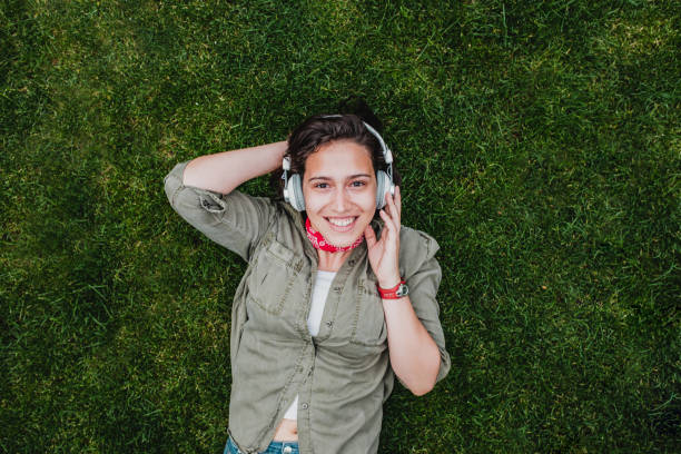 istock Young woman relaxing on the grass 1224223662
