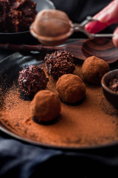 istock Date energy ball with cocoa on a black dish and cocoa nibs. 1224227743