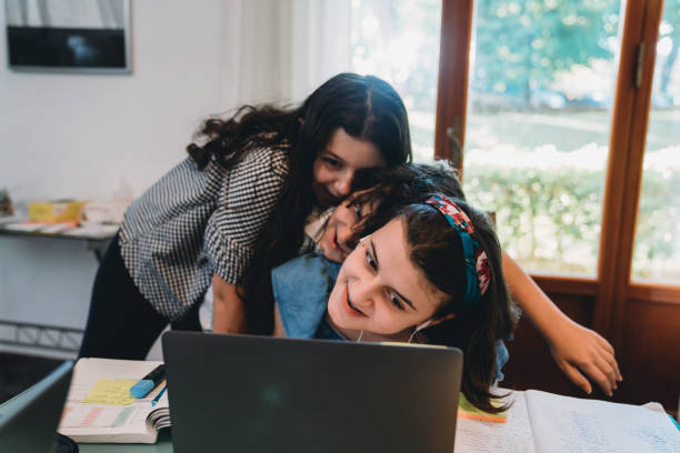 istock Brothers and sisters having fun together with a laptop 1224229101