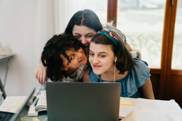 istock Brothers and sisters having fun together with a laptop 1224229105
