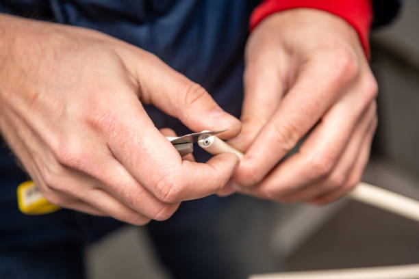 istock Cutting cable insulation with a segmented knife. White cable, yellow knife. Close-up. Horizontal orientation 1224229728