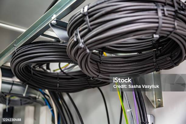 Cable Management. Working Wires, Black Cables Wound into a Coil, a