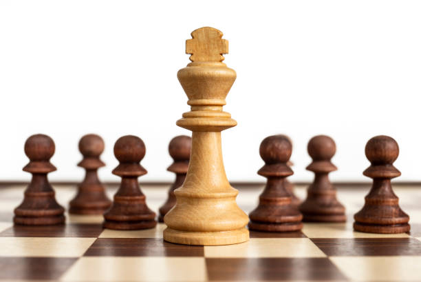 istock White king surrounded by black pawns 1224231768