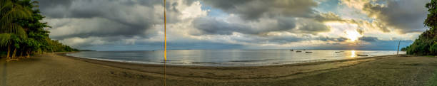 istock Tropical Bali beach at sunset with cloudy sky. Panoramic view 1224232810