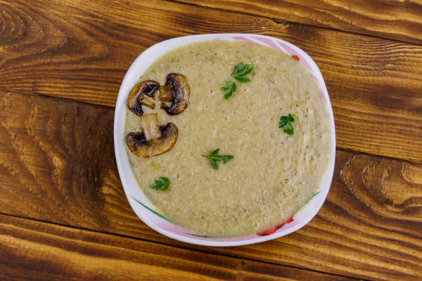istock Mushroom cream soup on a wooden table. Top view 1224234130