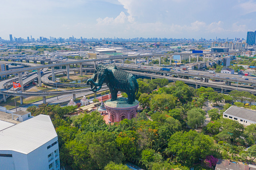 Aerial view of Erawan Museum is a Elephant head sculpture with 3 heads. Tourist attraction of Samut Prakan district with Downtown Bangkok. Urban city at noon, Thailand. Thai landmark architecture.