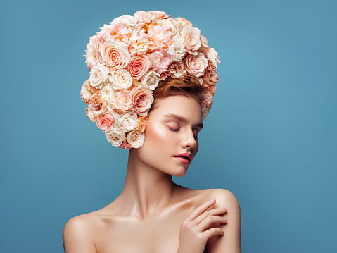 Young beautiful girl with wreath of flowers on her head