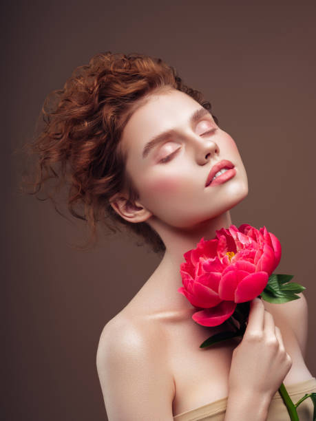 istock Beautiful woman with big flower. Natural soft make-up. 1224235708