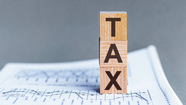 istock TAX - concept on cubes and diagrams on a gray background. 1224236819