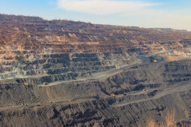 istock Huge iron ore quarry with working dump trucks and excavators 1224239253