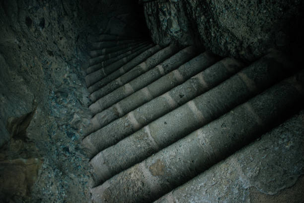 stone stairs path way of medieval cold dungeon prison cave perspective foreshortening corridor down to shadow