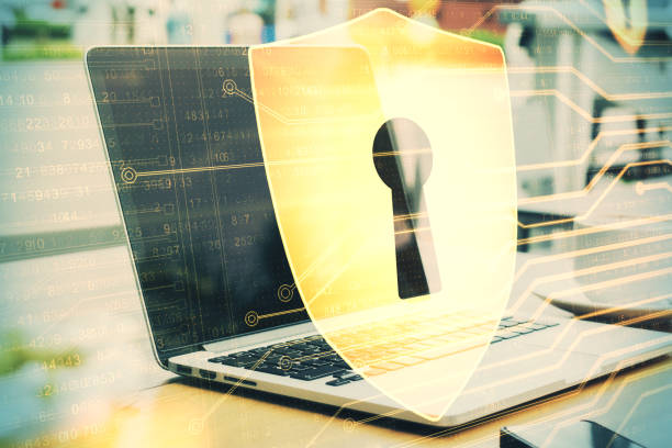 istock Laptop on table with antivirus shield hologram. 1224241308