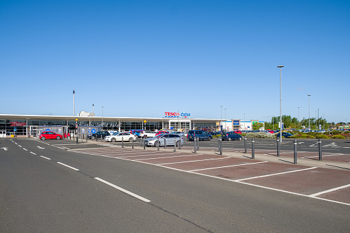 Irvine, Scotland, UK - May 11, 2020: Tesco Extra Store before the rush and an almost empty carpark during Covid-19 Lockdown I Scotland.