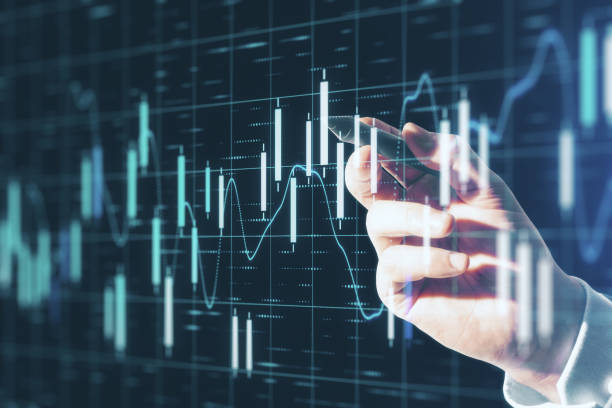 istock Trading concept with man hand pushing digital screen with going up graphs. 1224243955