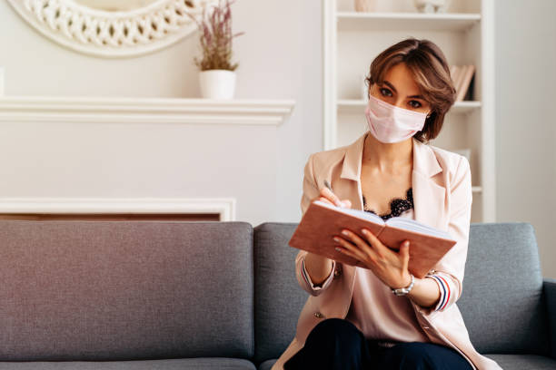 istock Young business woman working from home, wearing protective mask 1224244049