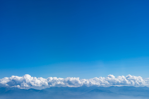 Clouds and Mountain range with blue sky background