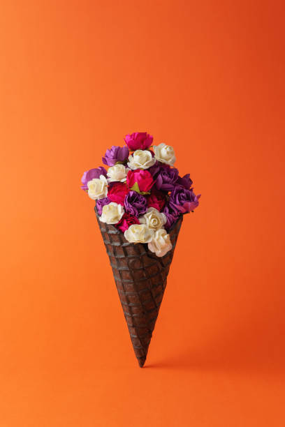 istock Black ice cream cone with colorful flowers on bright background. Minimal summer composition. 1224248205