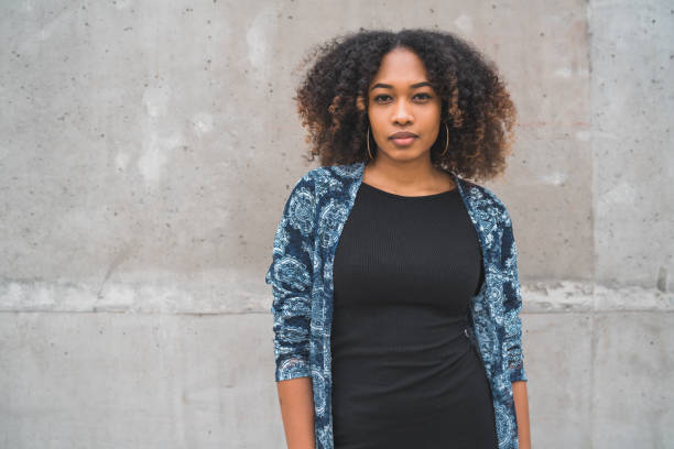 istock Afro-american woman against grey wall. 1224248246