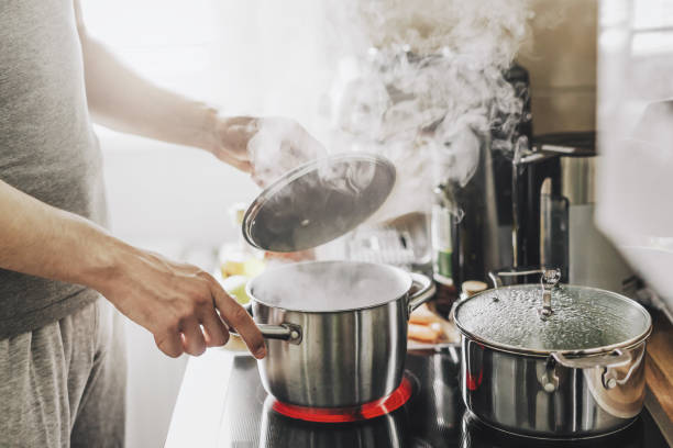 istock Man cooking fresh food at home 1224249284