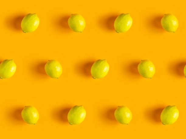 istock Citrus backdrop. Juicy ripe lemon  pattern on yellow background top. 1224249342
