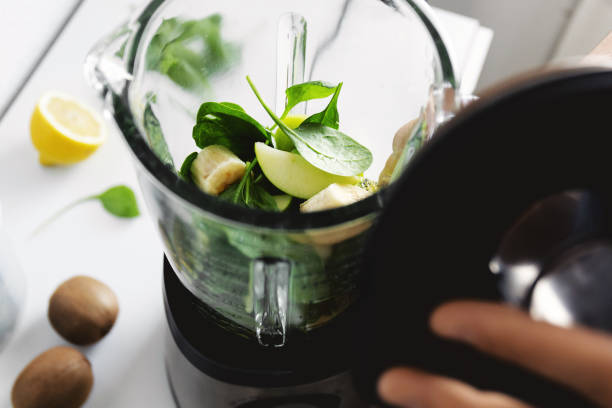 istock Man cooking smoothie in blender at home 1224249538