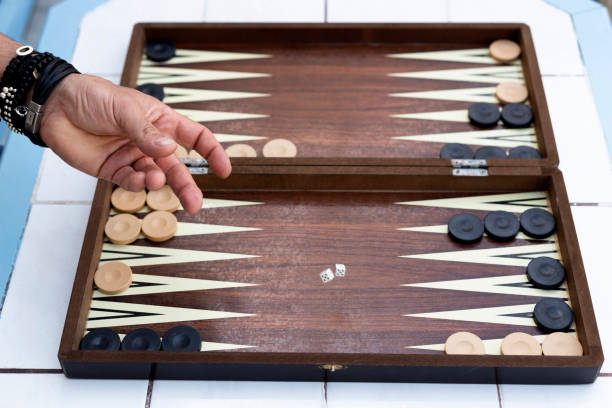 istock Two friends playing backgammon at home 1224250226