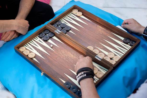 istock Two friends playing backgammon at home 1224250239