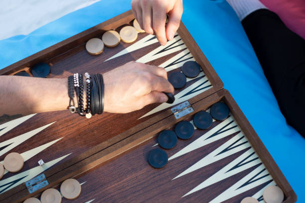 istock Two friends playing backgammon at home 1224250243