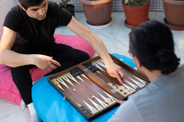 istock Two friends playing backgammon at home 1224250248