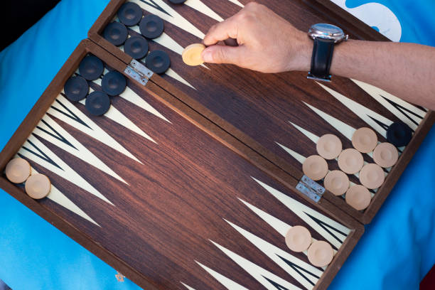 istock Two friends playing backgammon at home 1224250259