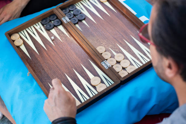 istock Two friends playing backgammon at home 1224250261