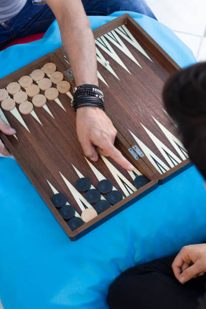 istock Two friends playing backgammon at home 1224250290