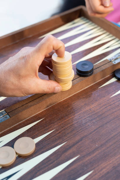 istock Two friends playing backgammon at home 1224250292