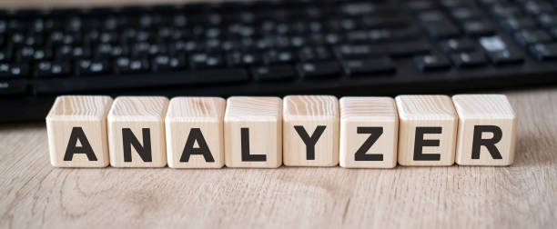istock Analizer - a tool used to analyze data. Text on wooden cubes and in the background black keyboard 1224250411
