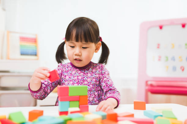 istock toddler girl playing creative toy blocks for homeschooling 1224251415