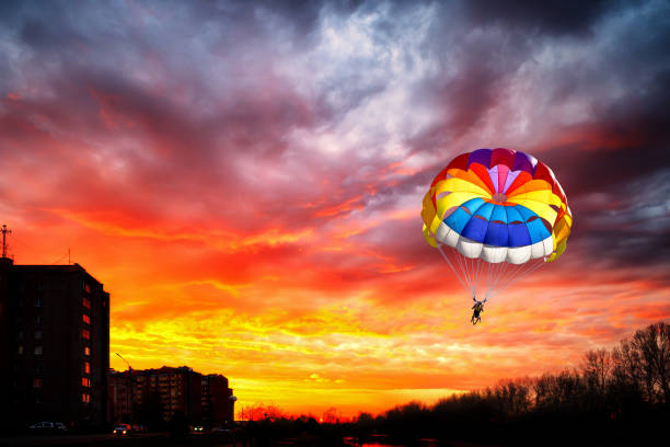 istock Paragliding with a parachute on the background of sunset. 1224252419