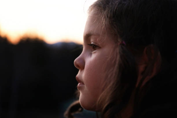 istock Profile of little girls face outside at dusk 1224253312