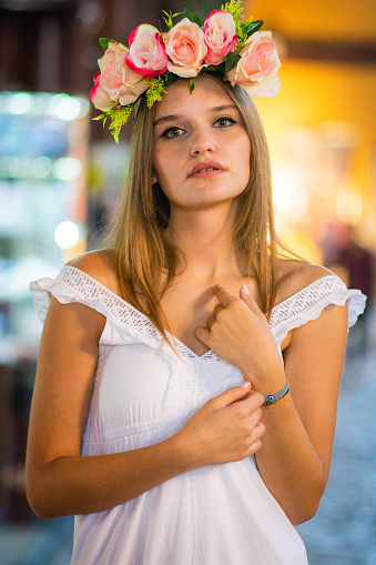 Young beautiful woman with crown of flowers on her head. close portrait