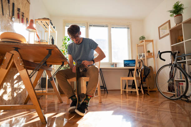 istock Smiling guy repairs his skateboard 1224255180
